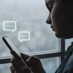 Girl texting friends to play an escape room on a rainy day