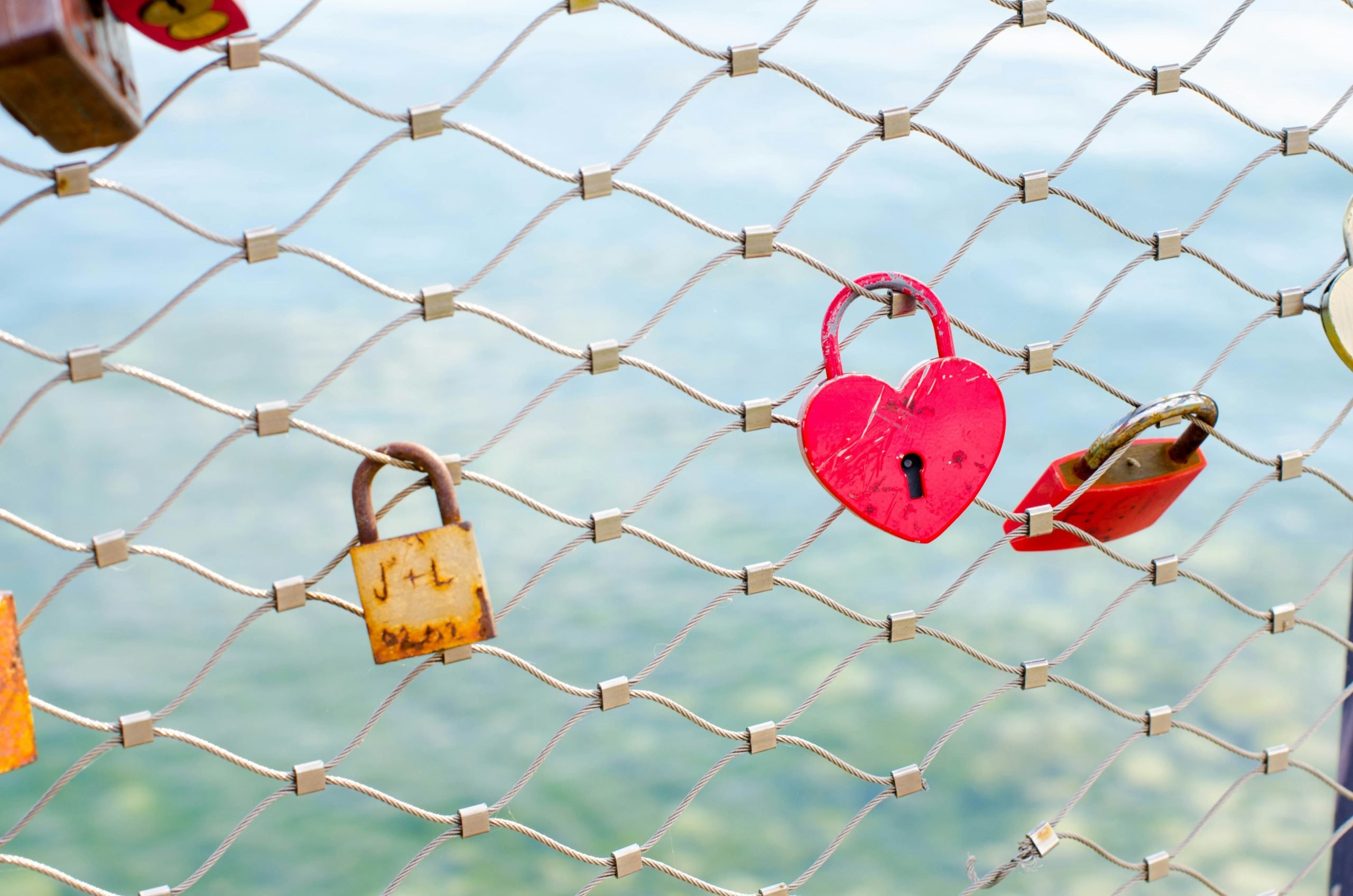 Locks on a fence with an ovean in the background symbolizing 5 things to do before summer ends